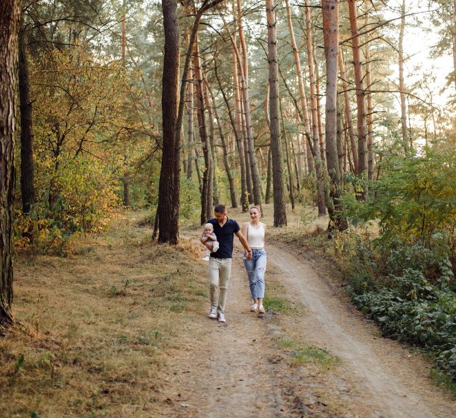 a family walking in the forest